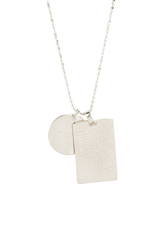 close-up-back-view-of-spell-s-taurus-stargazer-zodiac-necklace-charms-one-charm-is-of-a-rectangular-shape-and-an-inspirational-quote-while-the-other-charm-is-circular-the-brand-name